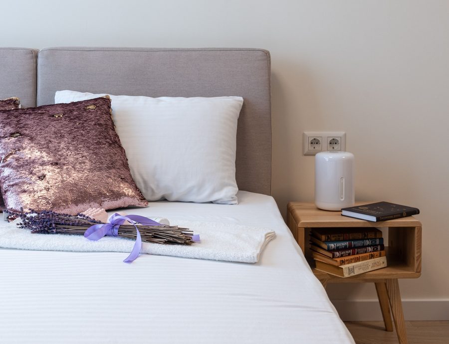 Bedroom with an ultrasonic essential oil diffuser on the nightstand